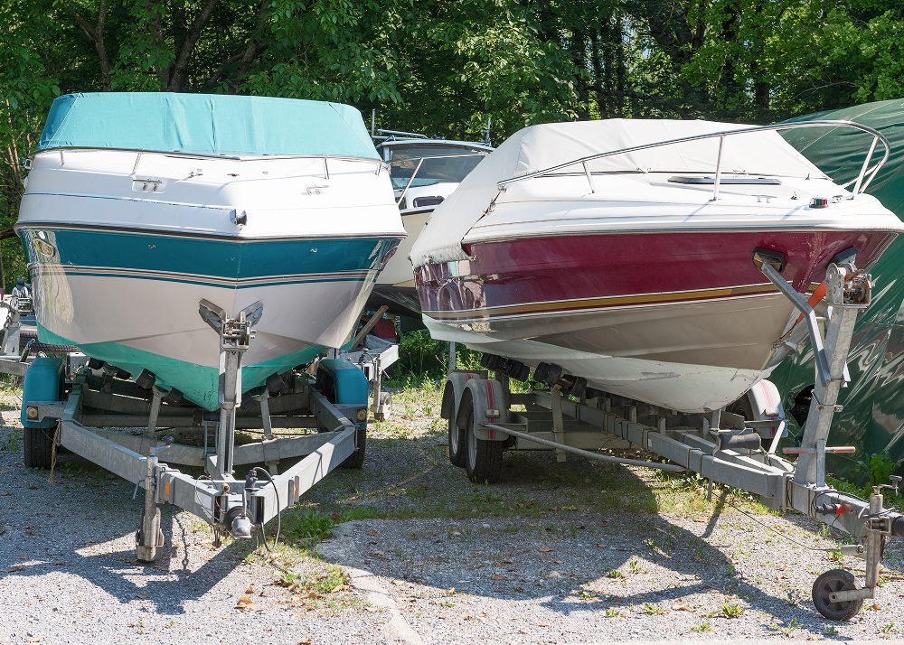 Two boats on trailers in sunlight
