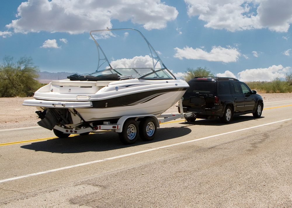 SUV towing a boat on highway