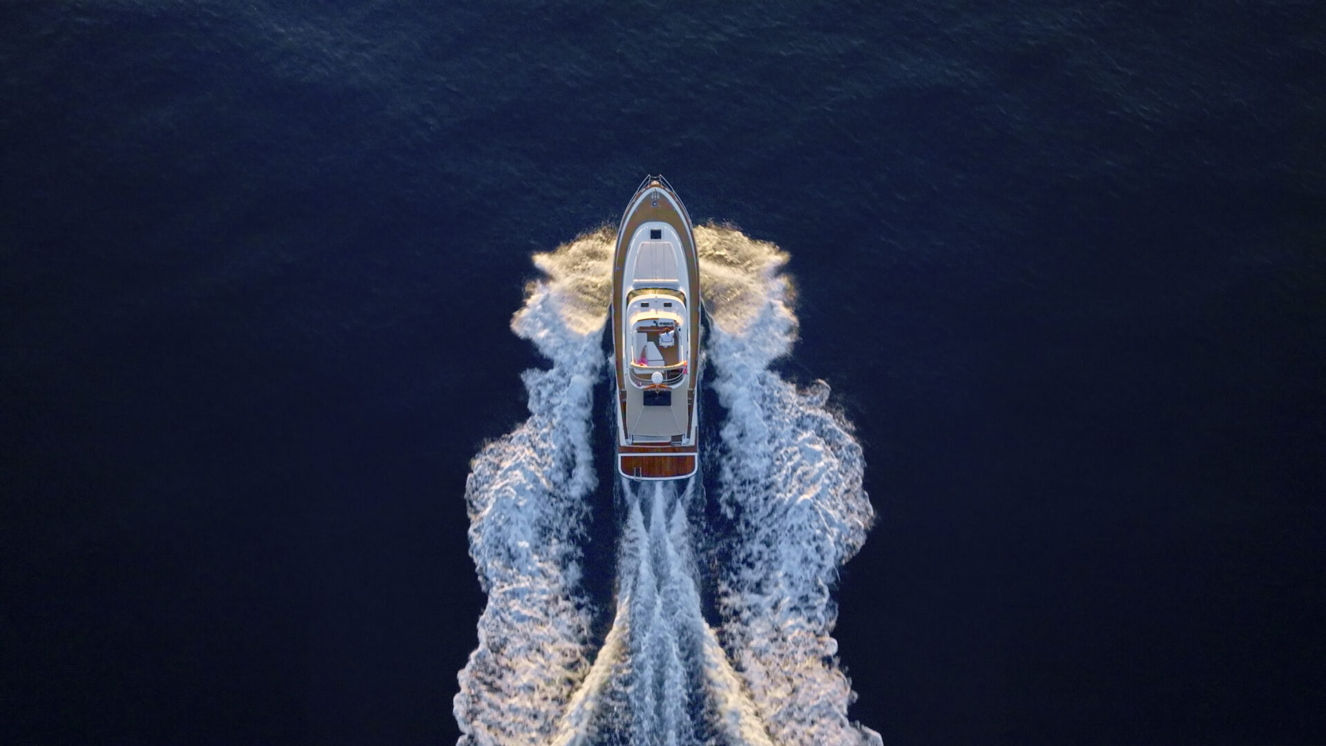 Aerial view of luxury yacht moving fast at Adriatic sea during sunny day.