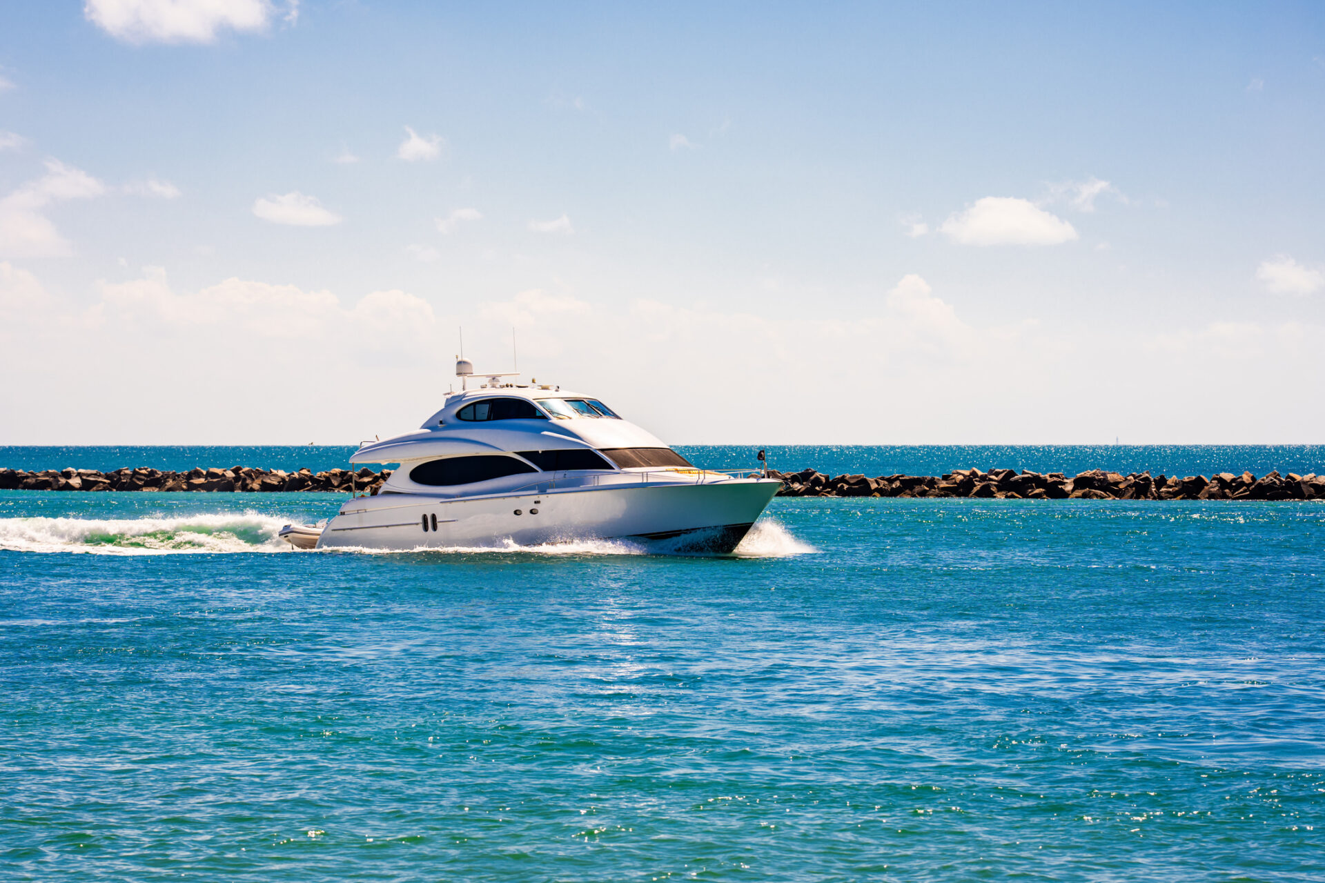 Yacht sailing on sea waters. Luxury superyacht at sea. Miami Beach with yachts. Seascape with a sailboat. Cruise ship near the coastline. Sunset yacht voyage in Florida. Luxury sailboat yacht