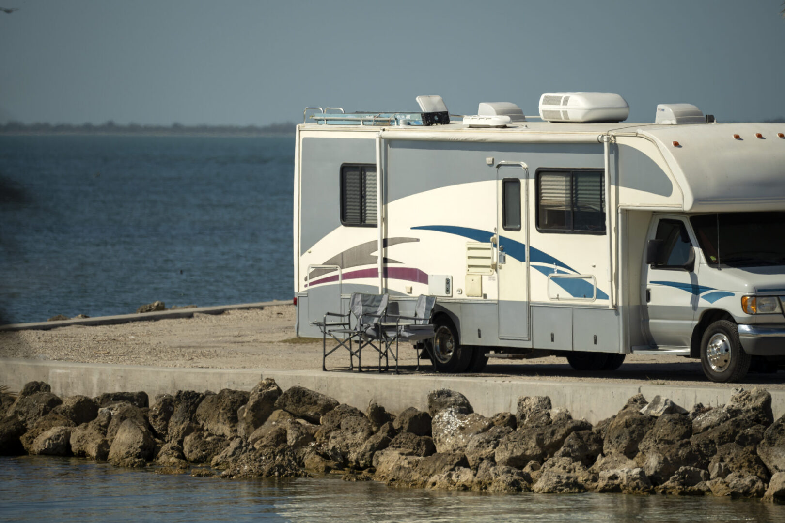 American motorhome parked on ocean shore in Florida. USA travel destination infrastructure